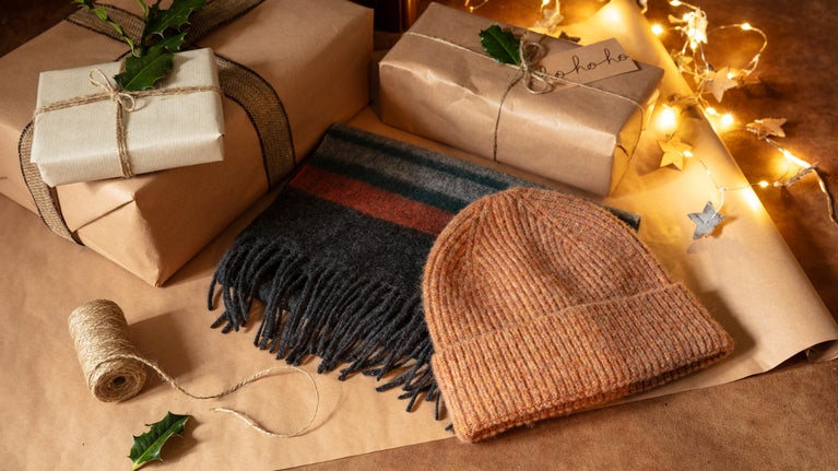 A selection of gifts for men, including a hat and scarf, from the A/W 2025 collection